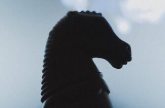 Moody silhouette of a chess knight with a blurred background, evoking strategic contemplation.