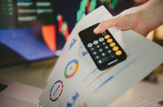 a person holding a calculator over a piece of paper