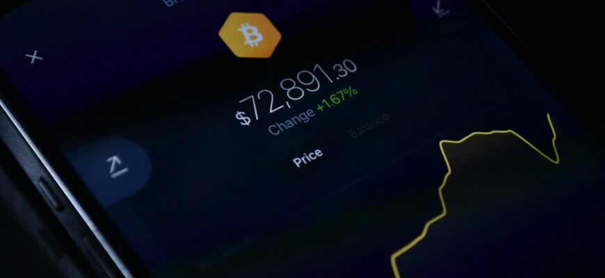 a close up of a cell phone with a bitcoin on it