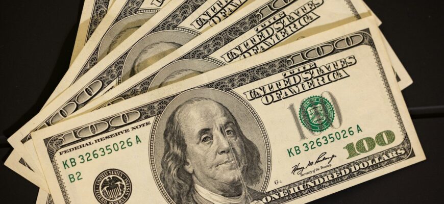 a stack of twenty dollar bills sitting on top of each other