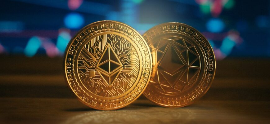 two gold coin sitting on top of a wooden table