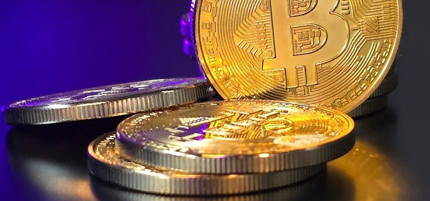 a pile of gold bitcoins sitting on top of a table