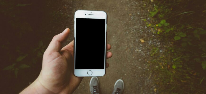 person holding silver iPhone 6 with black case
